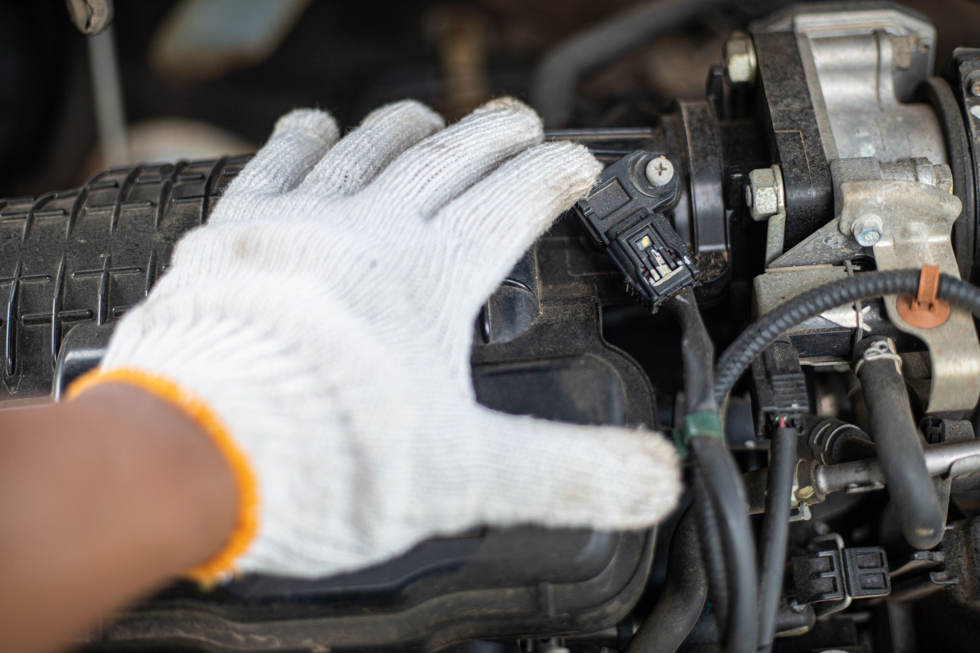 A person is working on a car engine